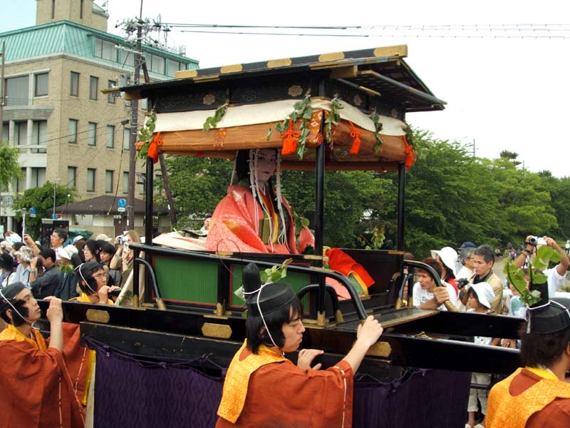 A maiko being carried in one of the floats at the Aoi Matsuri