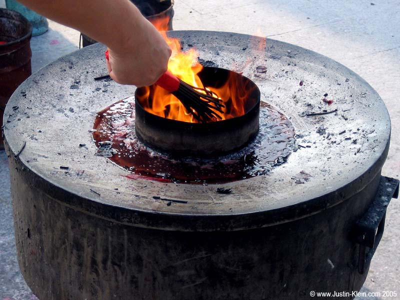 Lighting some incense at a temple in Shanghai.