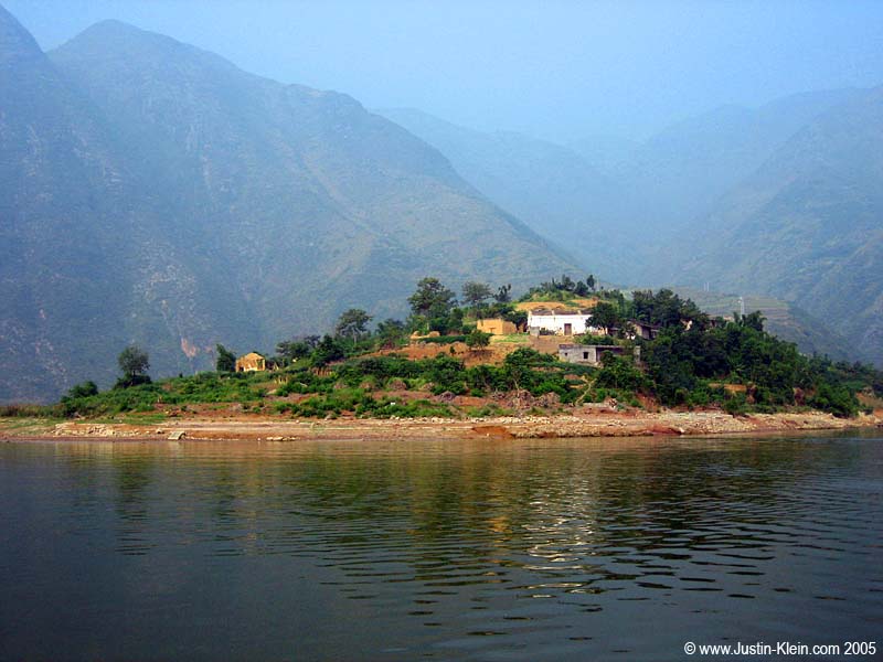 A small island with a few farmhouses somewhere along the Yangtze.  This island will be completely submerged by the time the damming project is complete and the river has risen to its final level 
