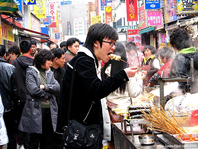 Enjoying a light snack of squirrel intestine on a stick.