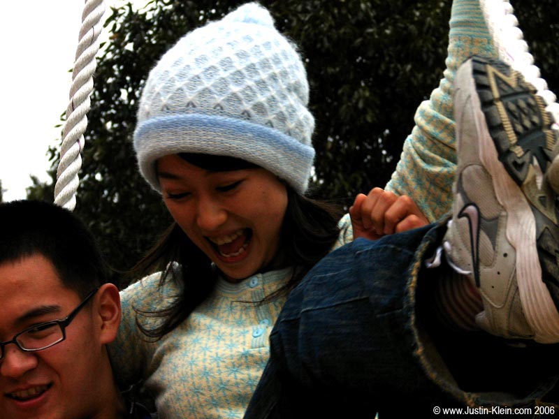 Chie's bro helping her down from the climbing rope