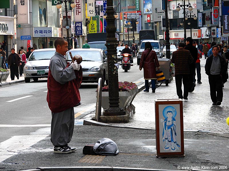 A monk begging for money. 