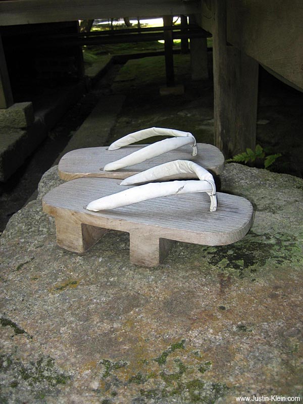 A pair of geta - traditional wooden sandals - in front of a buddhist temple in Kyoto.