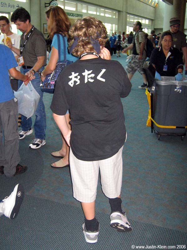 Nah, Comicon isn't for nerds or anything. (For the Japanese-impaired, this young man has written on his shirt a word meaning "snot-nosed socially inept anime/comic-book nerd." On his <i>own</i> shirt.)