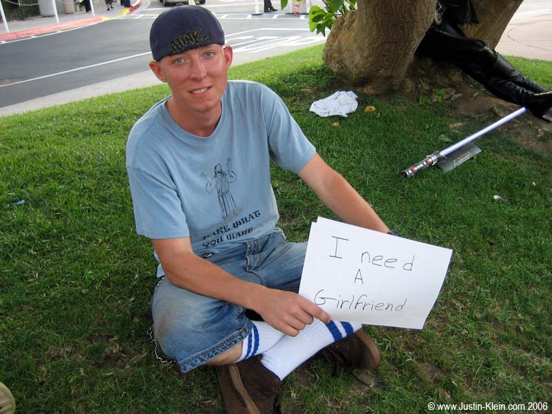 For the sake of this picture, he folded and concealed the lower half of the sign which contained his phone number. No joke.