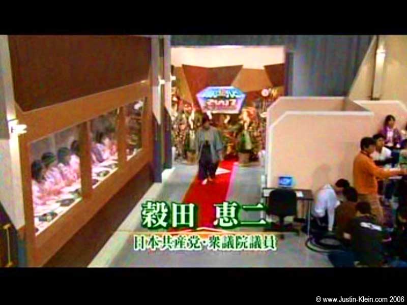 One of the Panelists coming into the studio. To the left is the army of Japanese phone-answering girls in pink. To the right is the audience stand where I was seated.