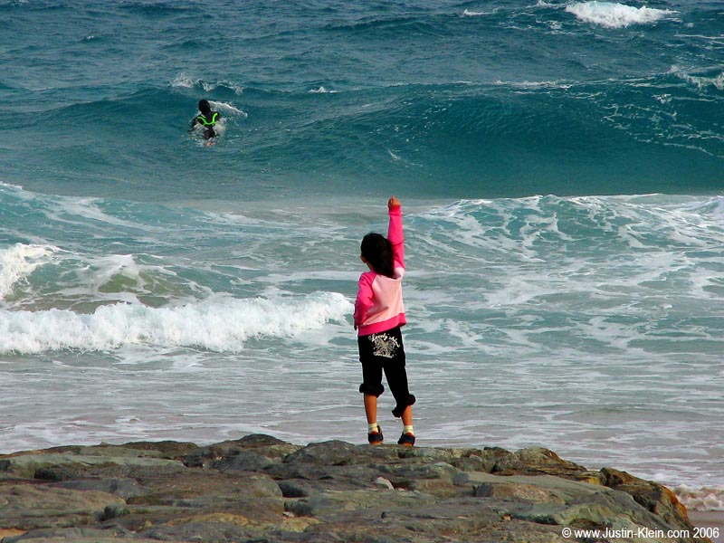 A little girl cheers on her father in the impossibly icy Shirahama waters. 