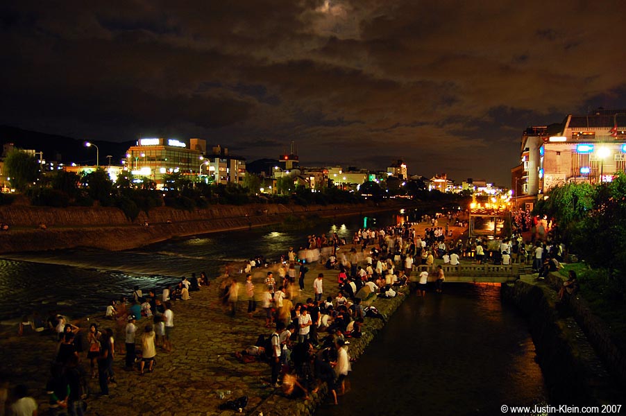 Young people hanging out at the Kamo river on an average Summer evening. God I love that place.