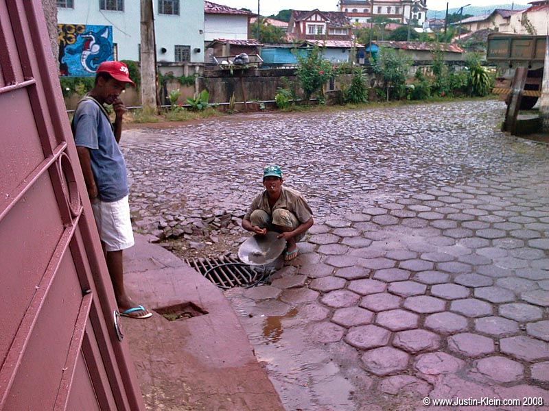 Some locals rinsing out their pan to see if any gold got left behind.