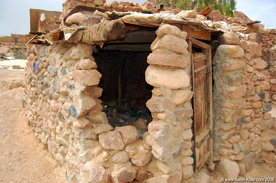 A fairly common unfinished structure - temporarily in use as a trashcan.