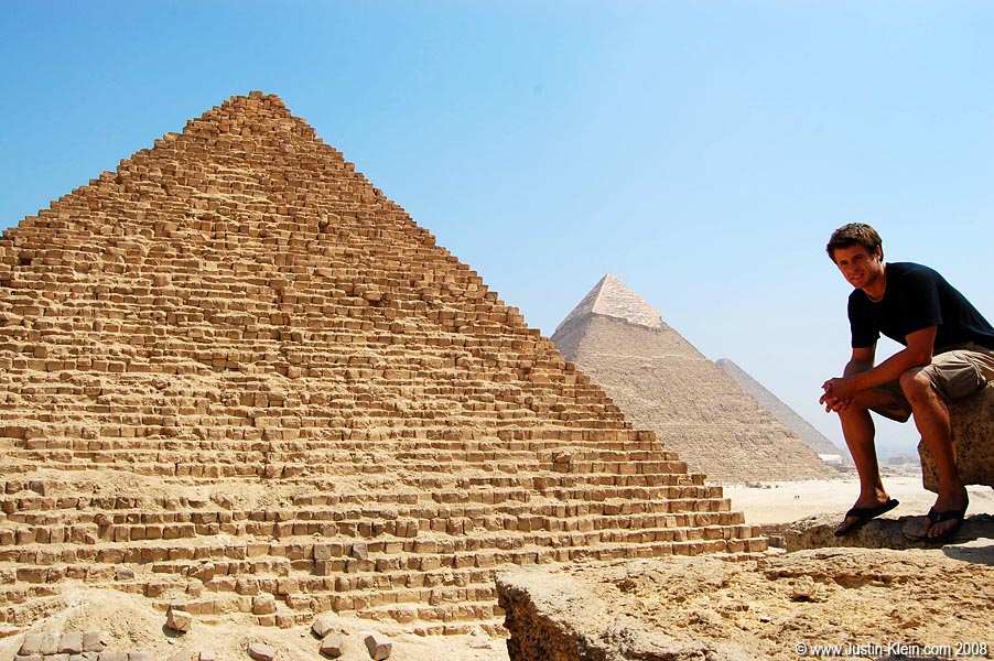 Sitting atop said small pyramid.