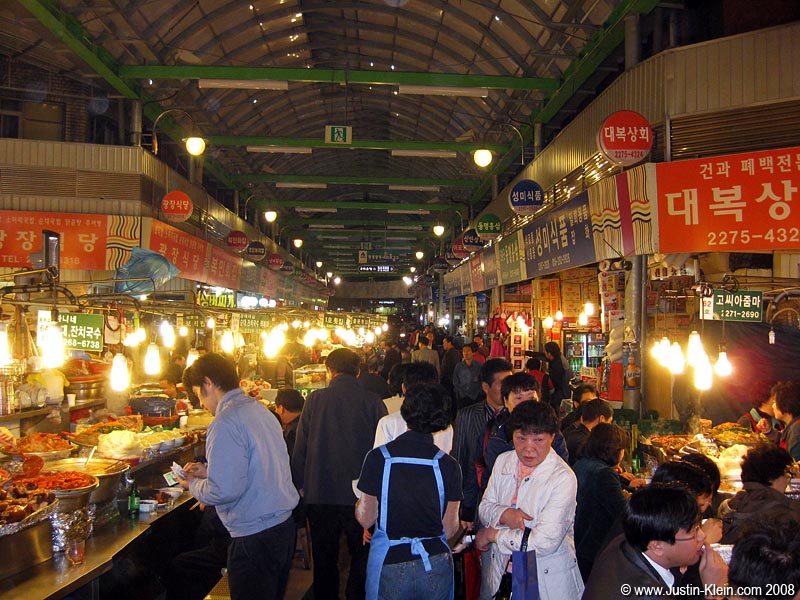 A covered shopping arcade, so crammed with food vendors you can scarcely manage to move.