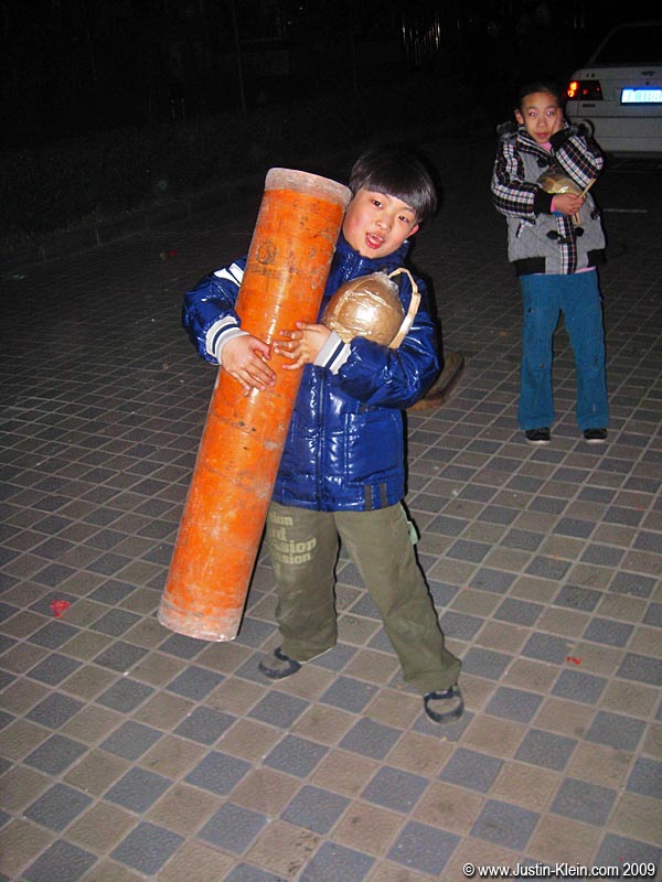 Junior helps carry out some of the ammunition. Look at the size of that shell - it's as big as his head!