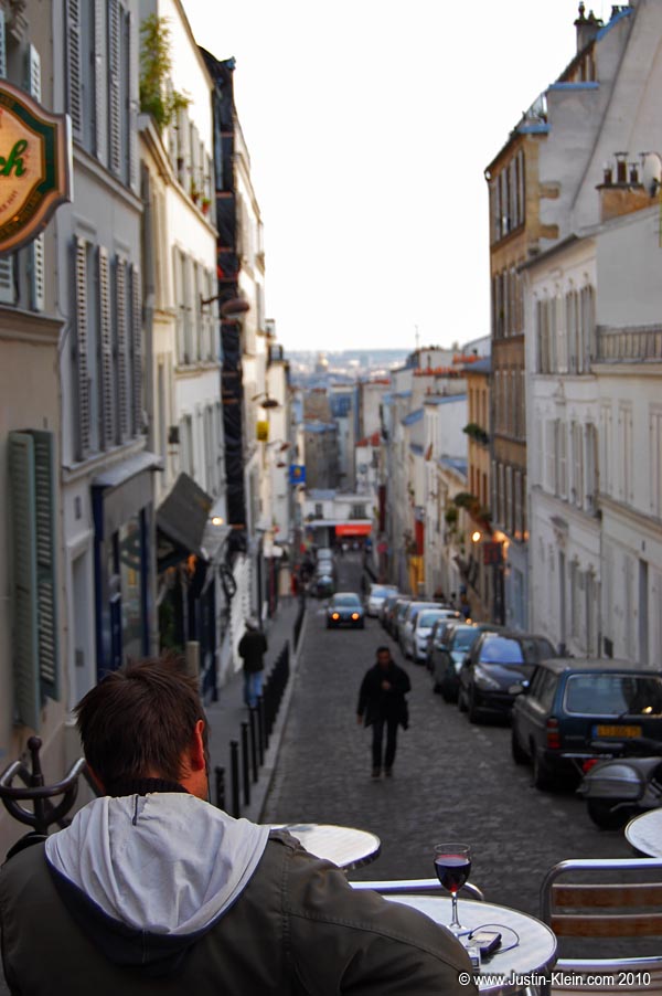 A glass of wine at a streetside cafe: the epitome of Paris.