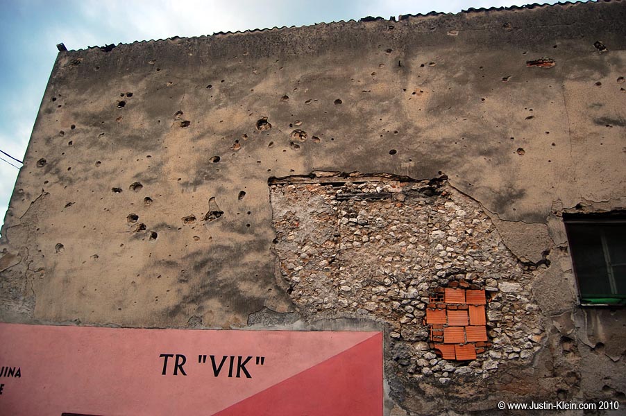 A building riddled with bullets...and something a bit larger.