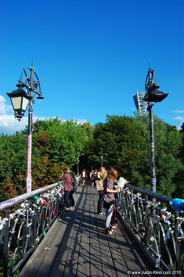 Teens socializing on a bridge that allows Misky Sad to sprawl across both sides of the major boulevard below.