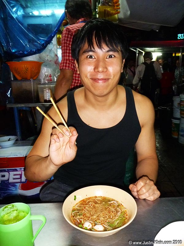 Herb getting ready to try some kind of spicy street soup.