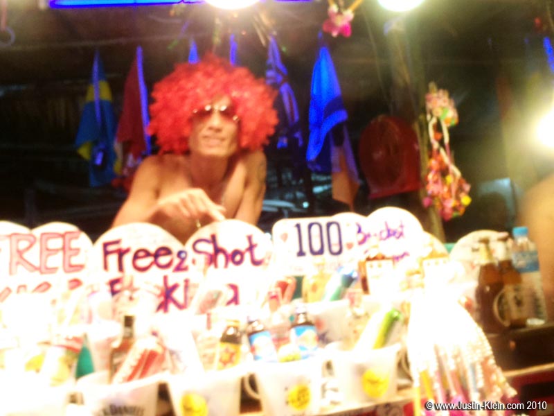 Down on the beach, competition to sell buckets is fierce. This guy roped us in with his outrageous wig and promise of free extra shots. He did not disappoint - even did one with us!
