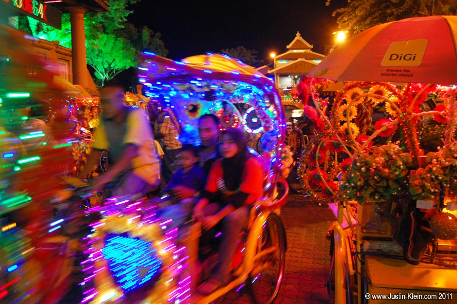 Outrageously decorated trishaws shuffle the tourists about.