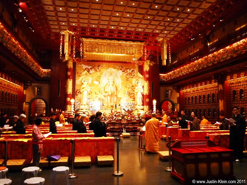 A Buddhist ceremony taking place in a temple across the road.